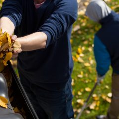 man cleaning gutter