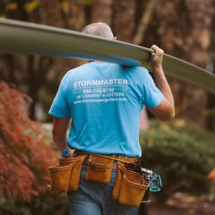man lifting a custom gutter